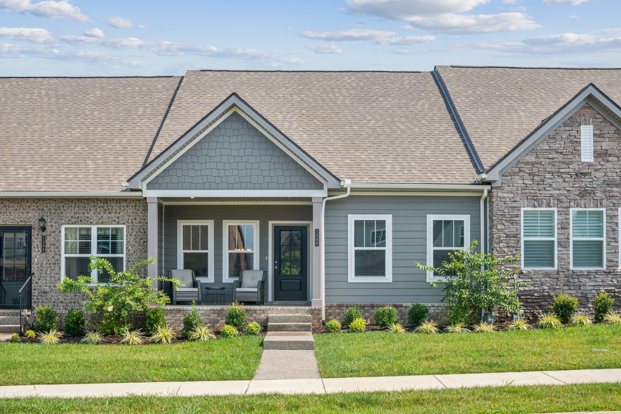 a front view of a house with a yard and porch