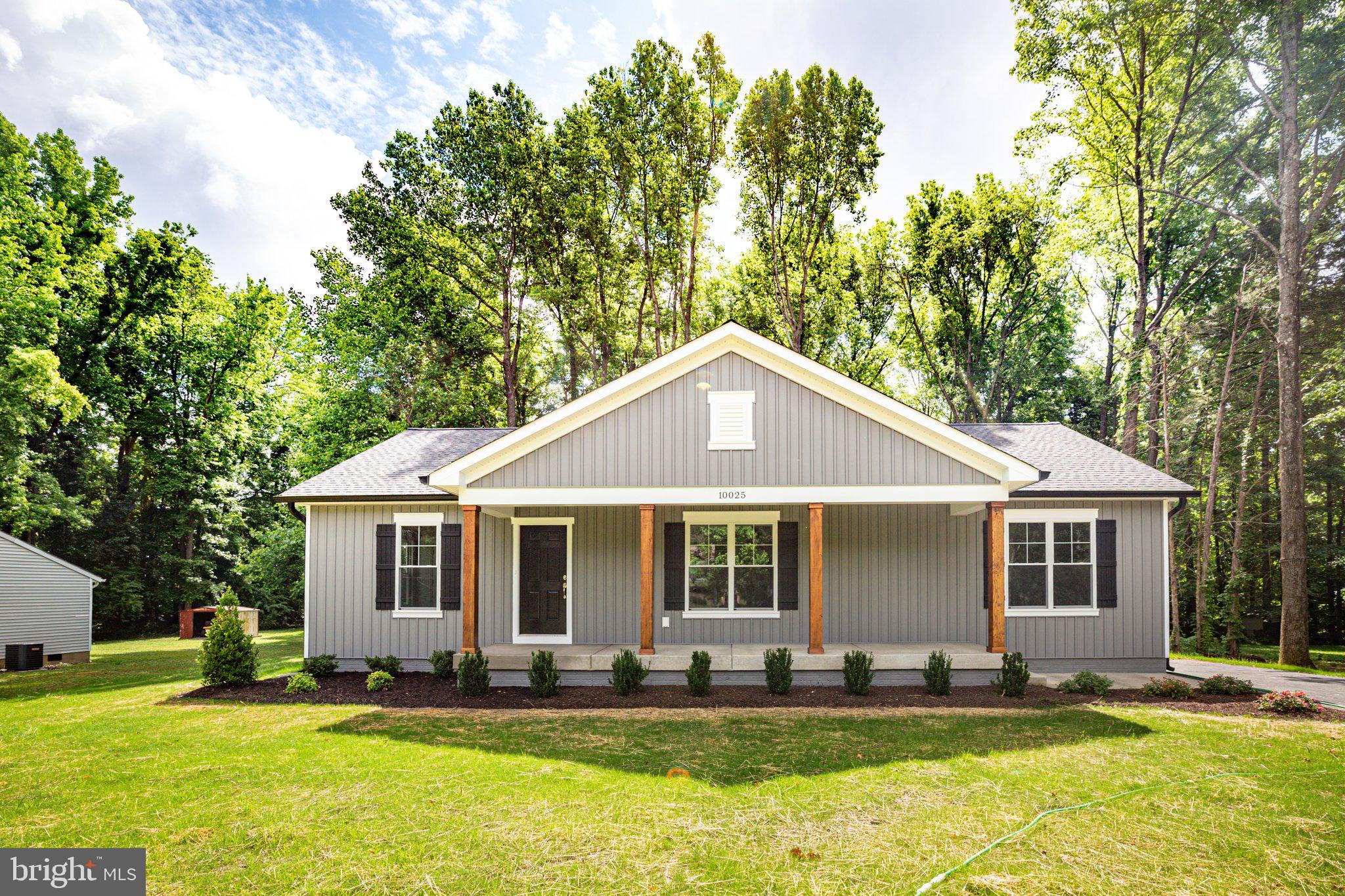 a front view of a house with a yard porch and outdoor seating