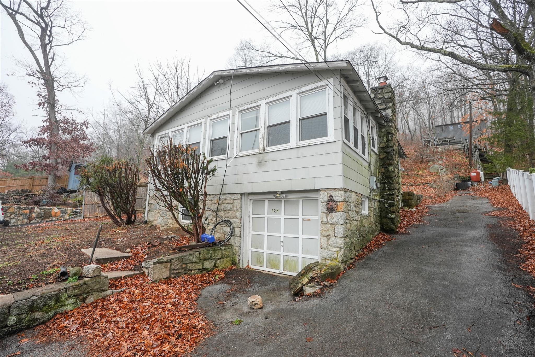 Front of home.  Neighboring house behind has easement to the driveway on the righthand side.