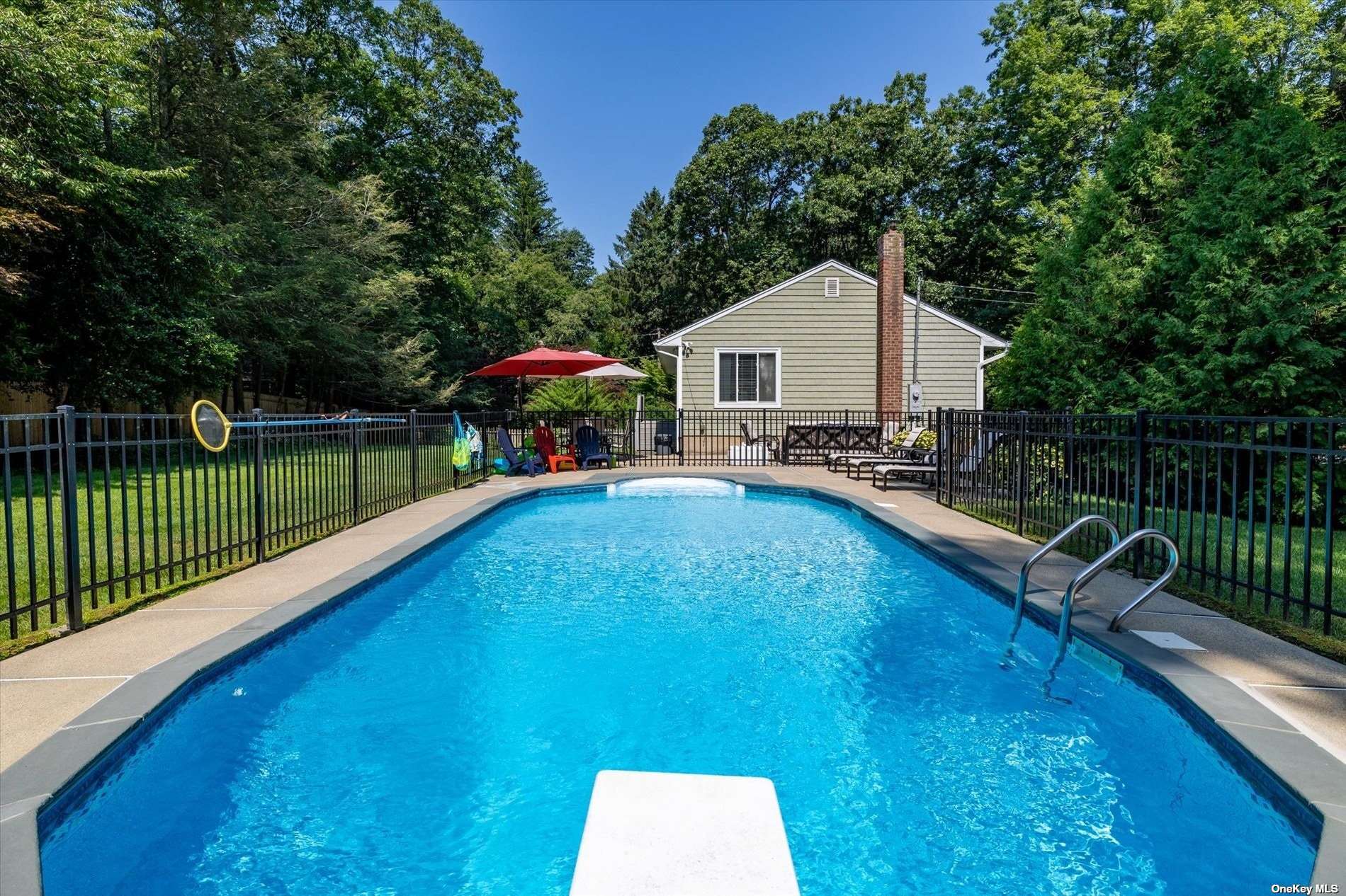 a swimming pool view with a seating space