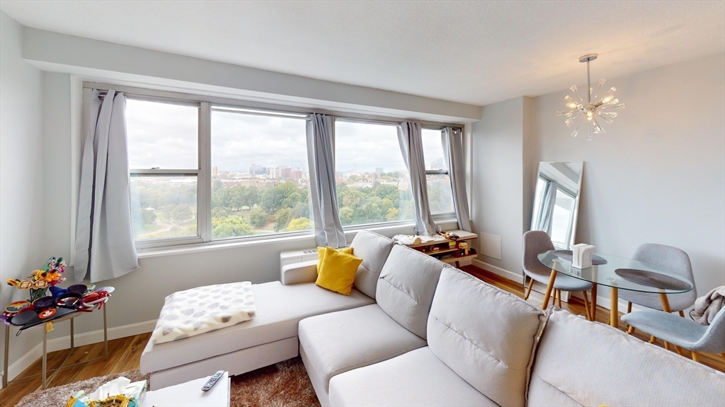 a living room with furniture and floor to ceiling windows