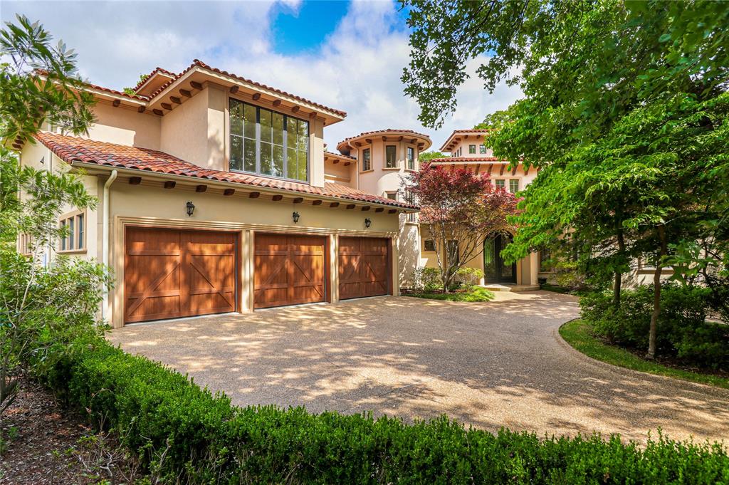 a front view of a house with a yard and a garage