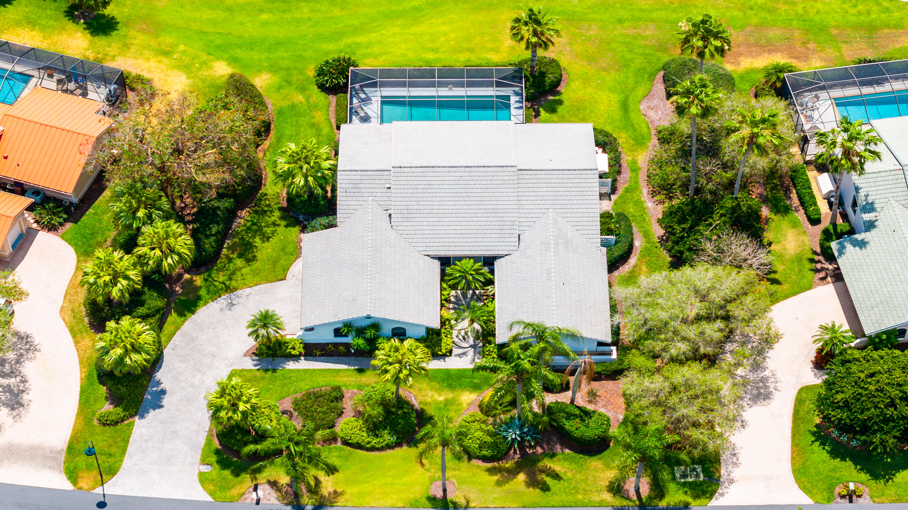 an aerial view of a house with large trees