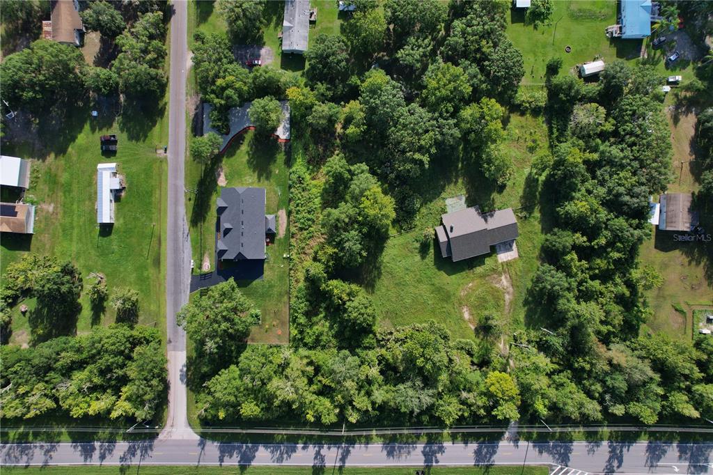 an aerial view of house with yard