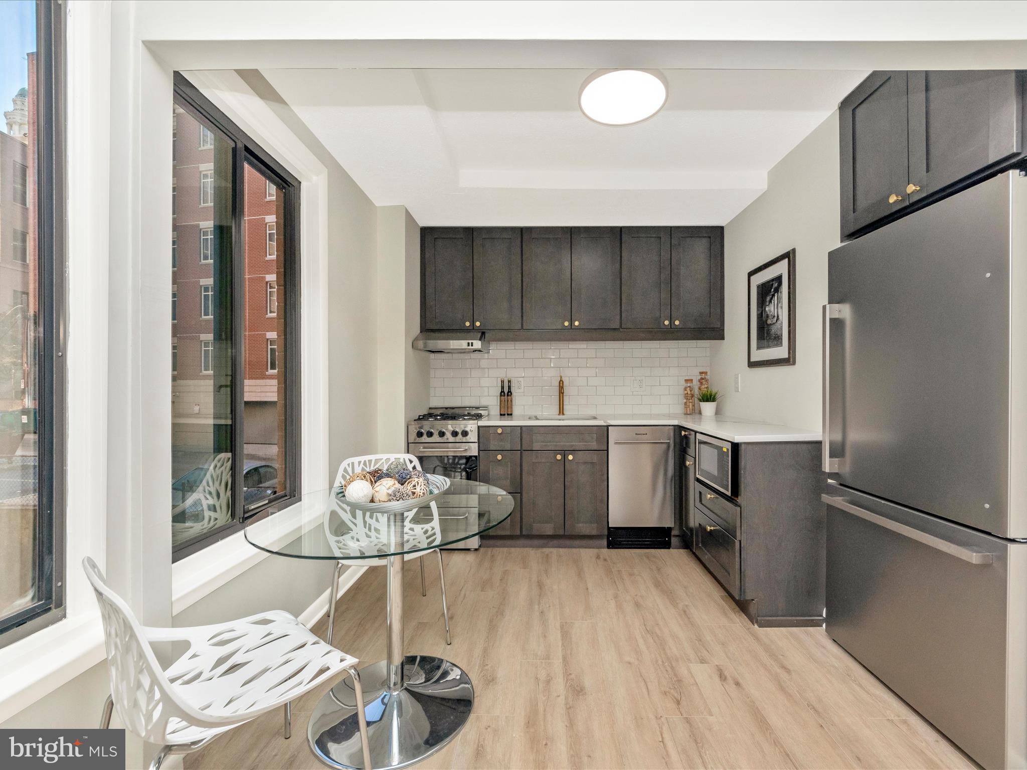 a kitchen with a refrigerator and cabinets