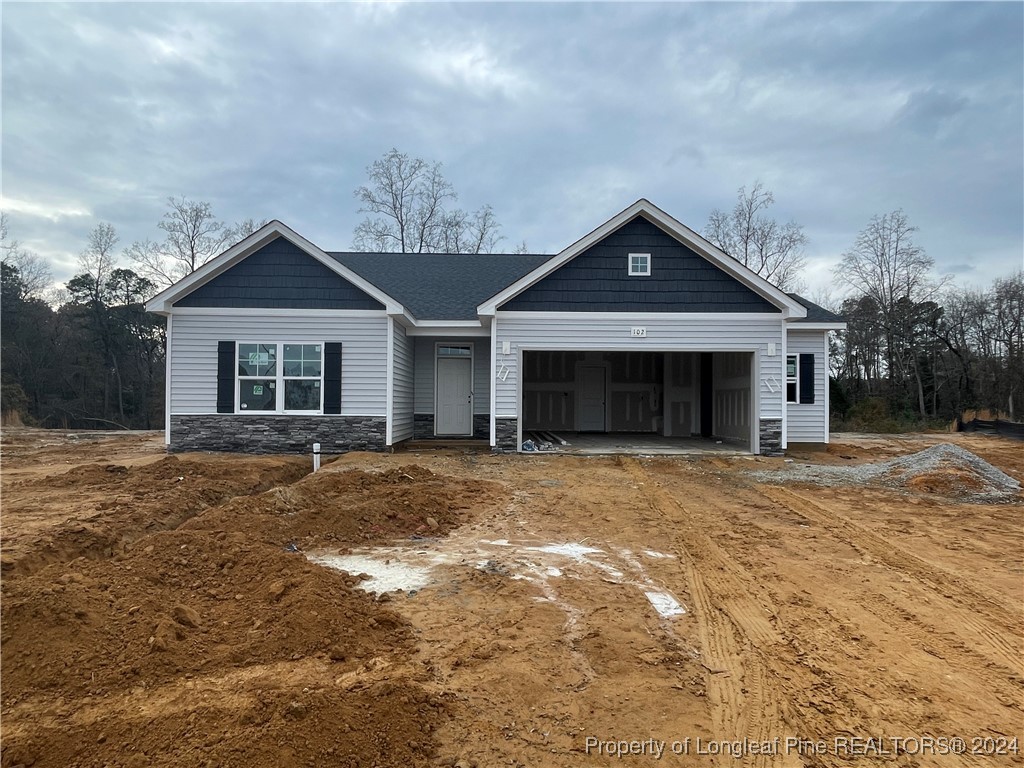 a front view of a house with a yard and garage