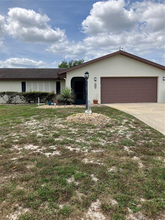 a view of a house with a yard and garage