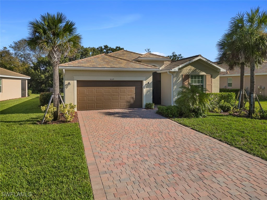 a front view of a house with a yard and garage