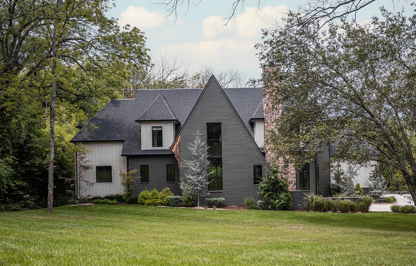 a front view of a house with a garden