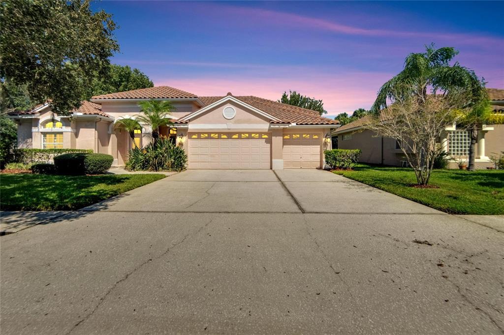 a front view of a house with a yard and garage