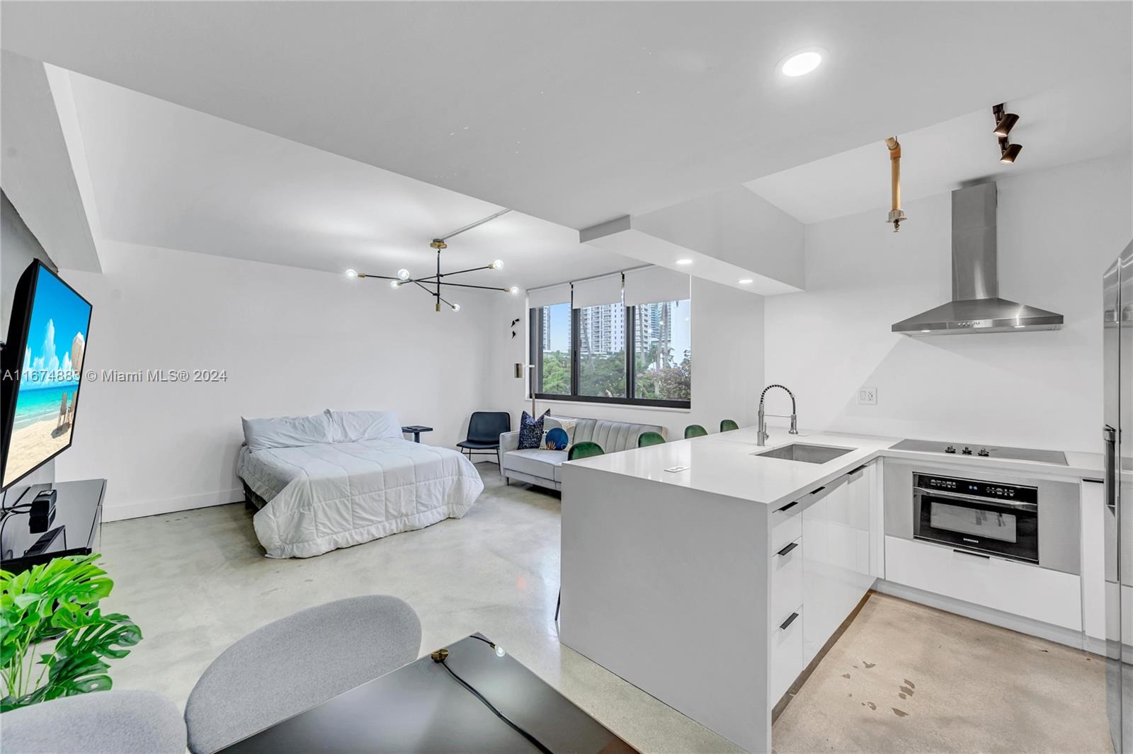 a kitchen with stainless steel appliances kitchen island granite countertop a sink and white cabinets