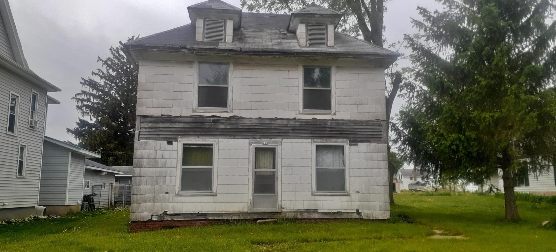 a front view of a house with a garden