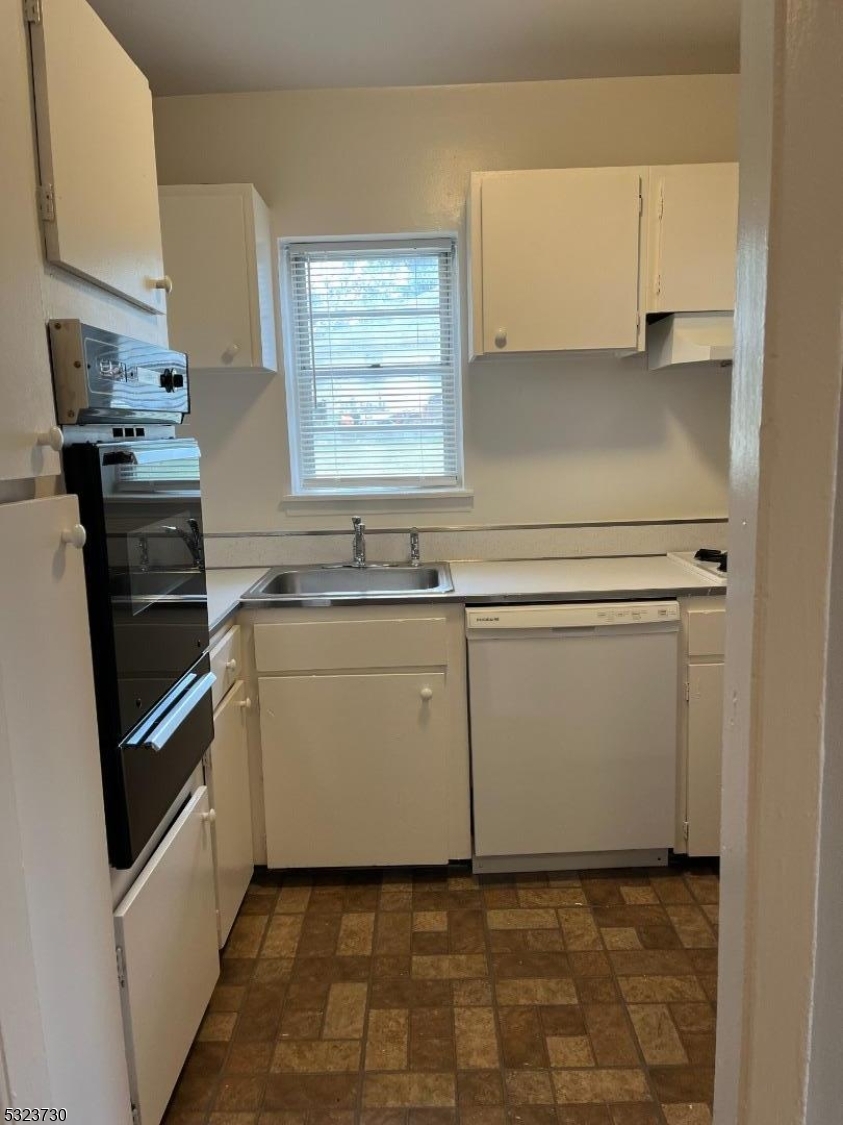 a utility room with cabinets washer and dryer