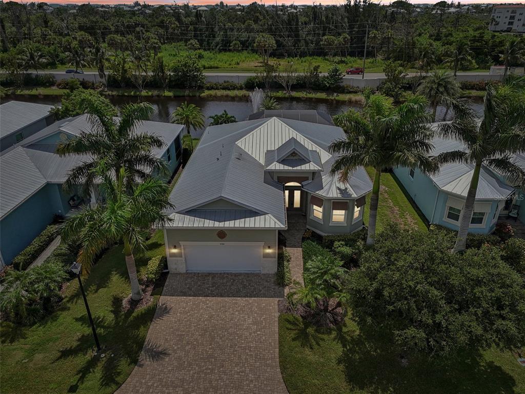 a aerial view of a house with a yard and lake view