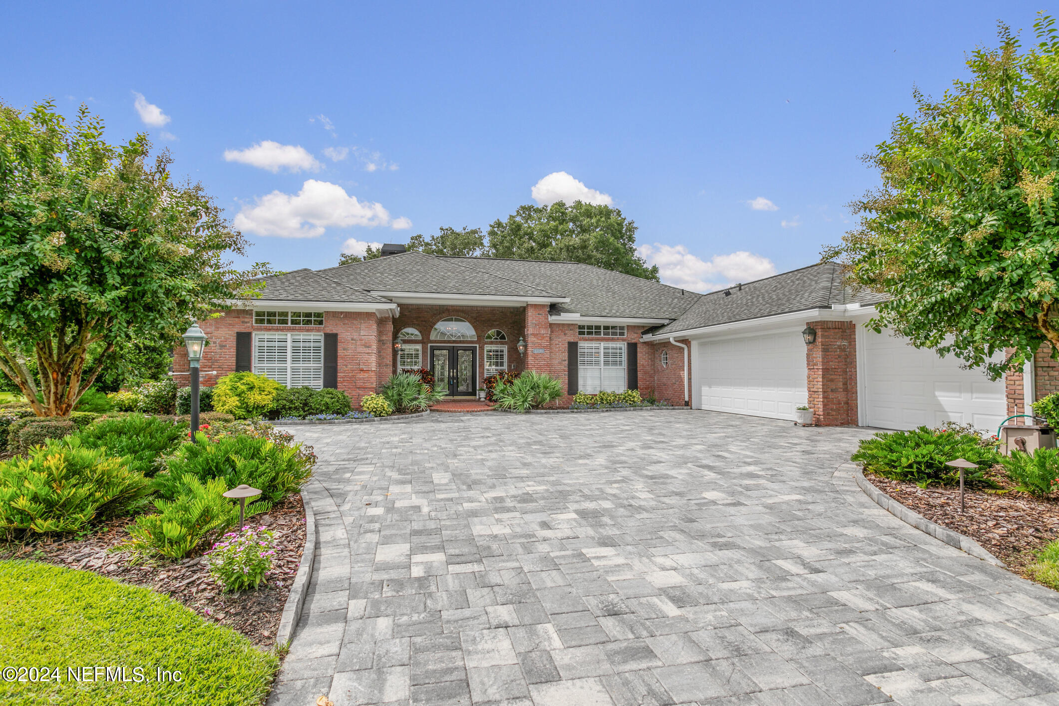 a front view of a house with a yard and a garage