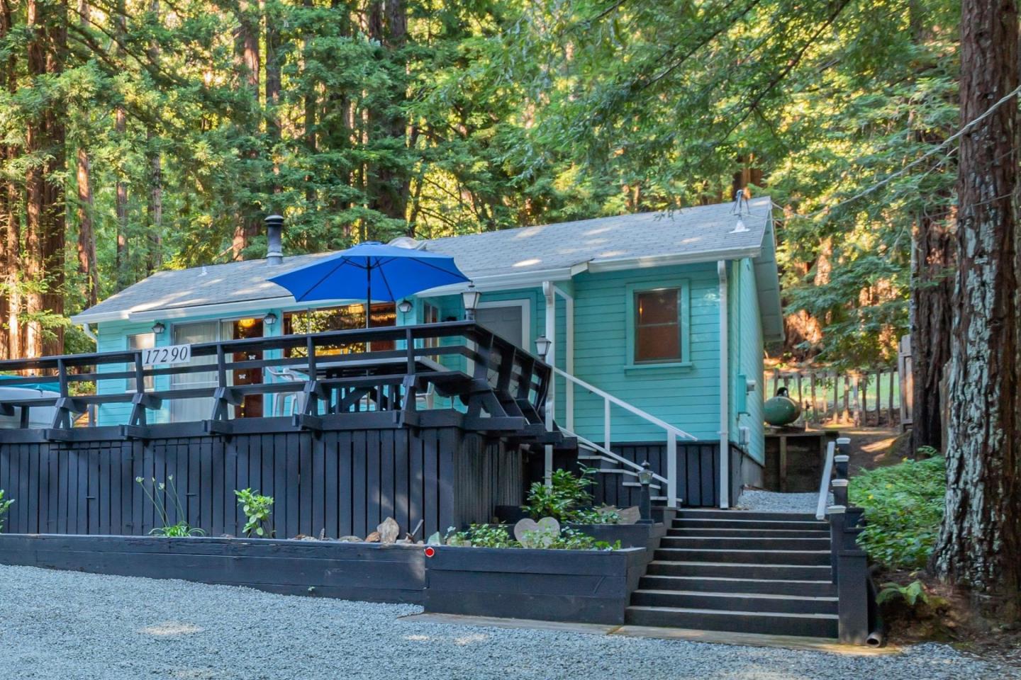 a view of a house with a yard and a patio