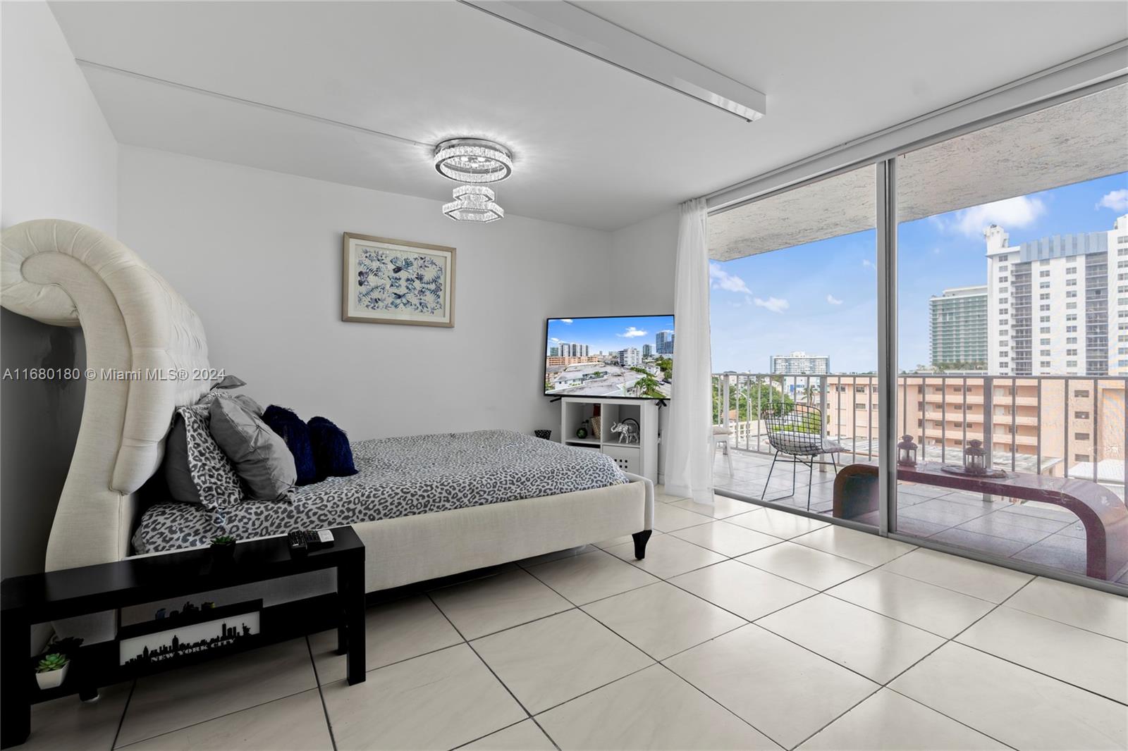 a bedroom with furniture and a large window