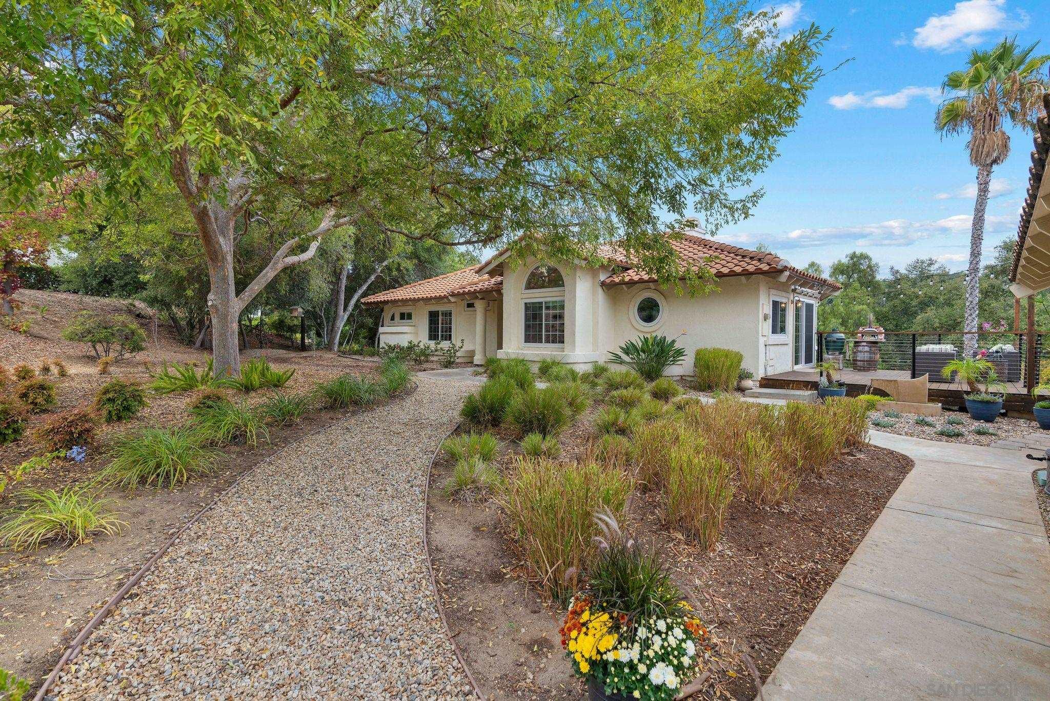 a front view of a house with a garden