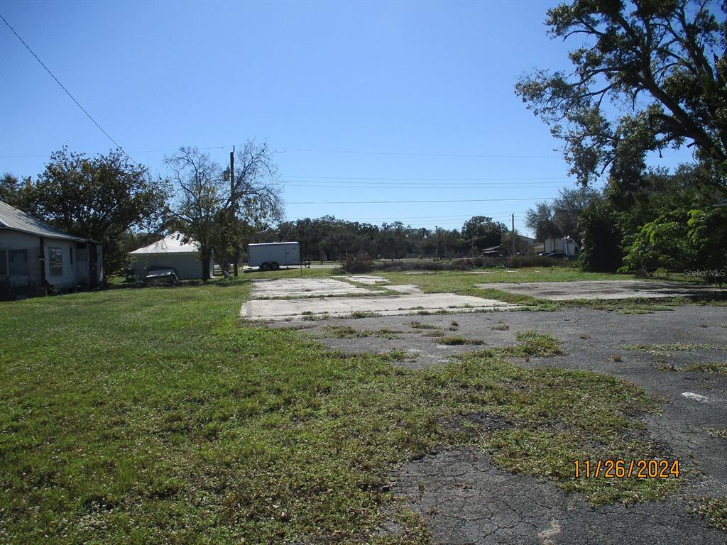 a view of a field of grass and trees