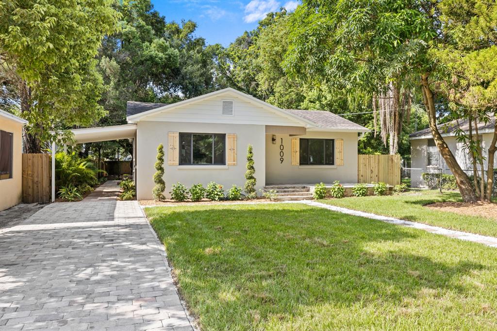 a front view of house with yard and green space