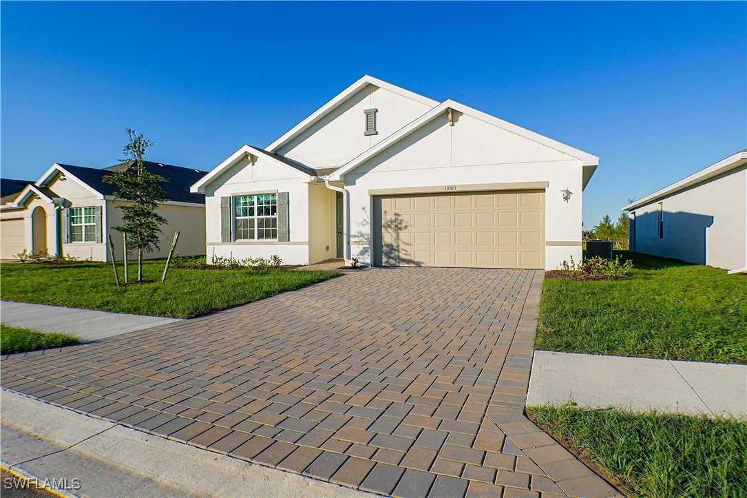 a front view of a house with a yard and garage