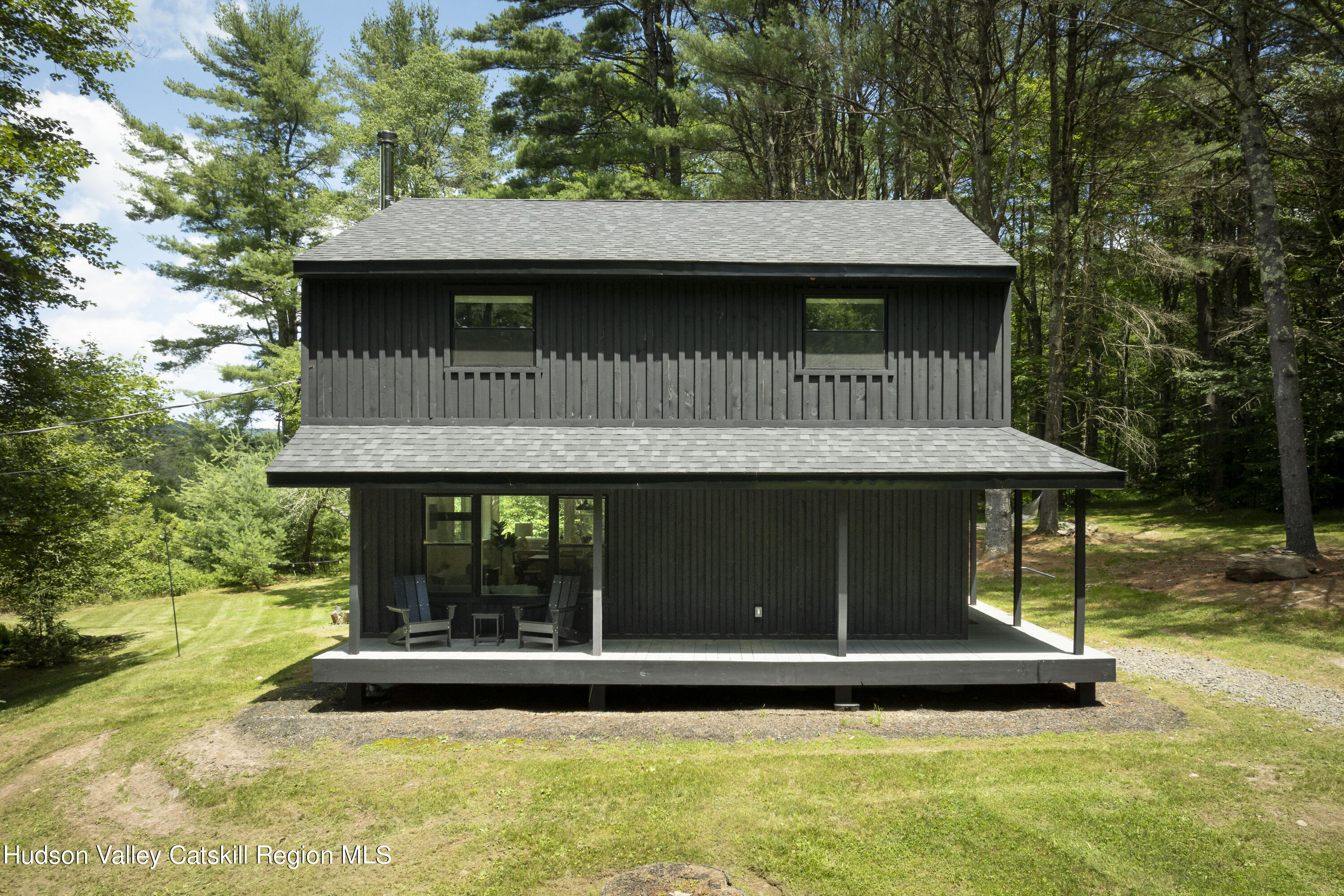 a view of a house with pool and chairs