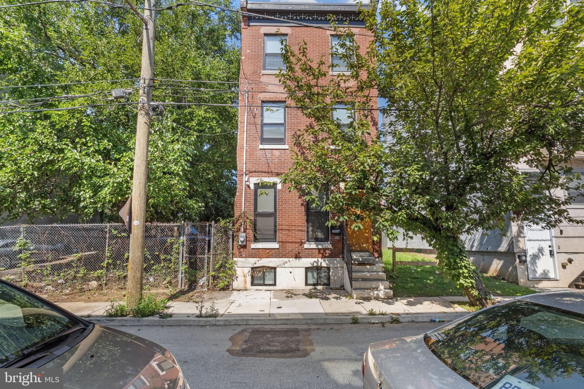 front view of a building with a tree