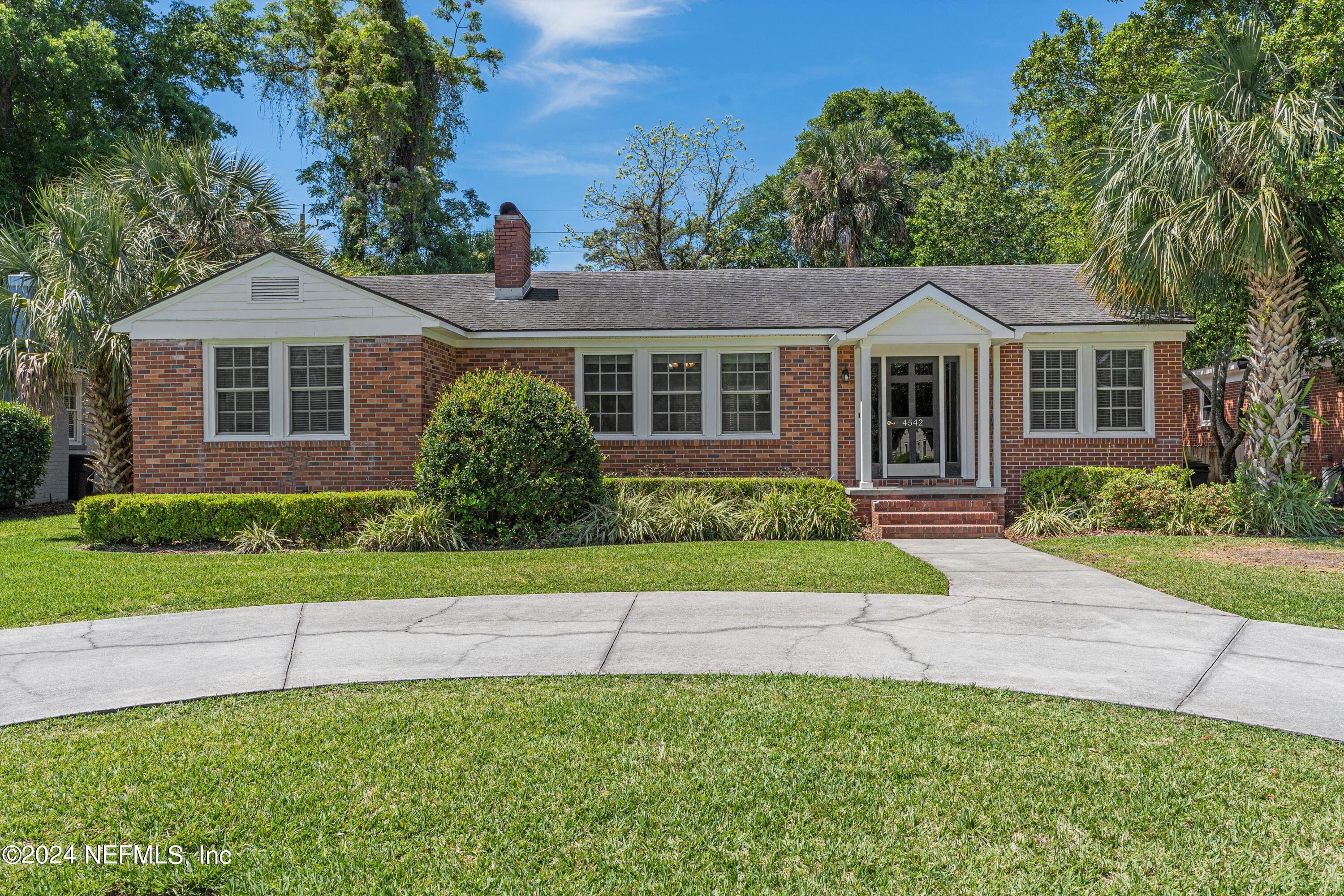 front view of a house next to a yard