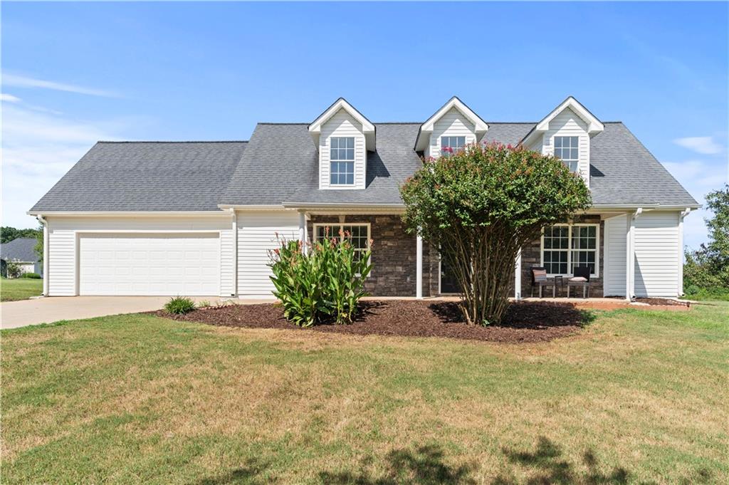 a front view of a house with a yard and garage