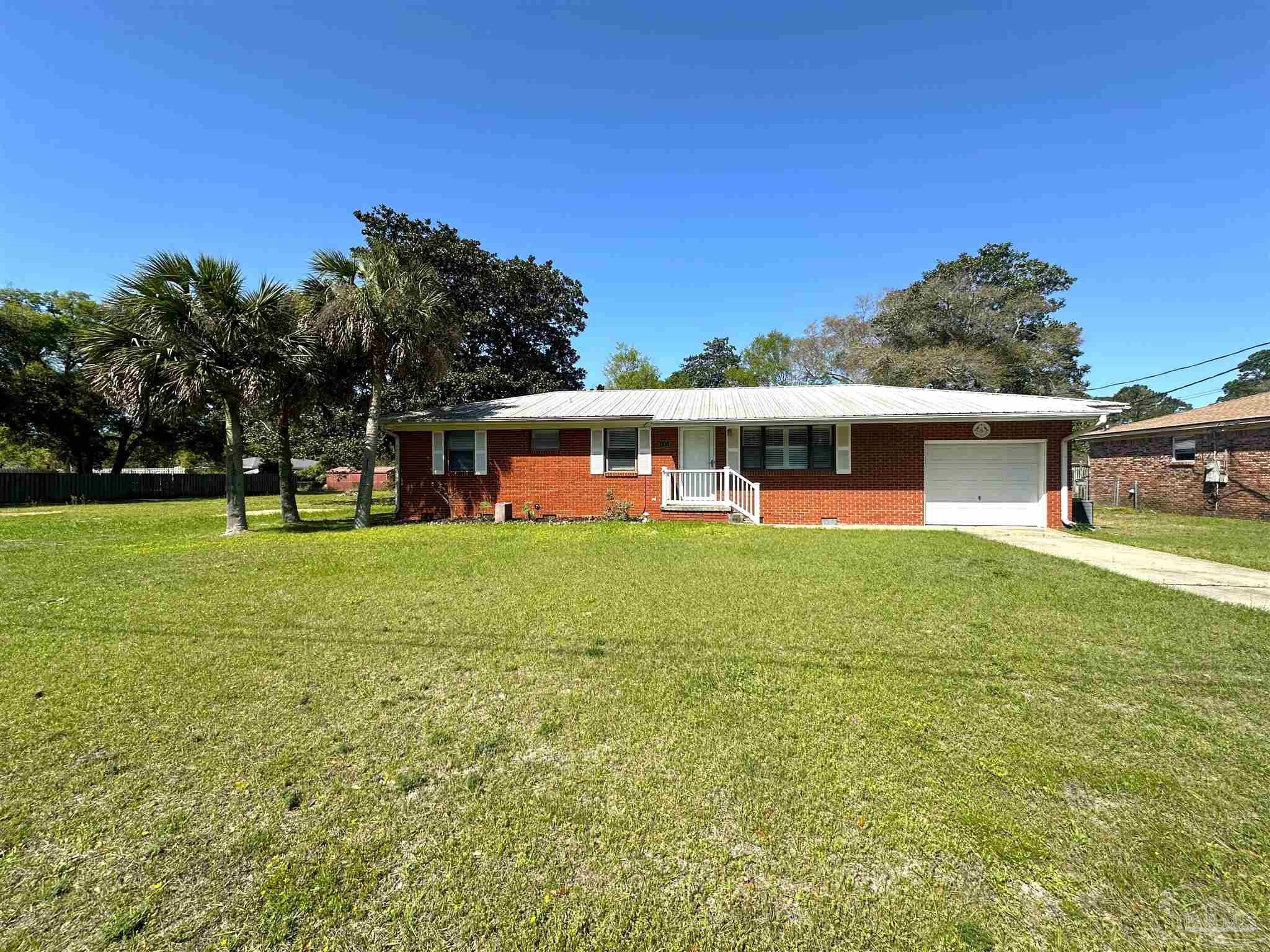 a view of a house with a backyard