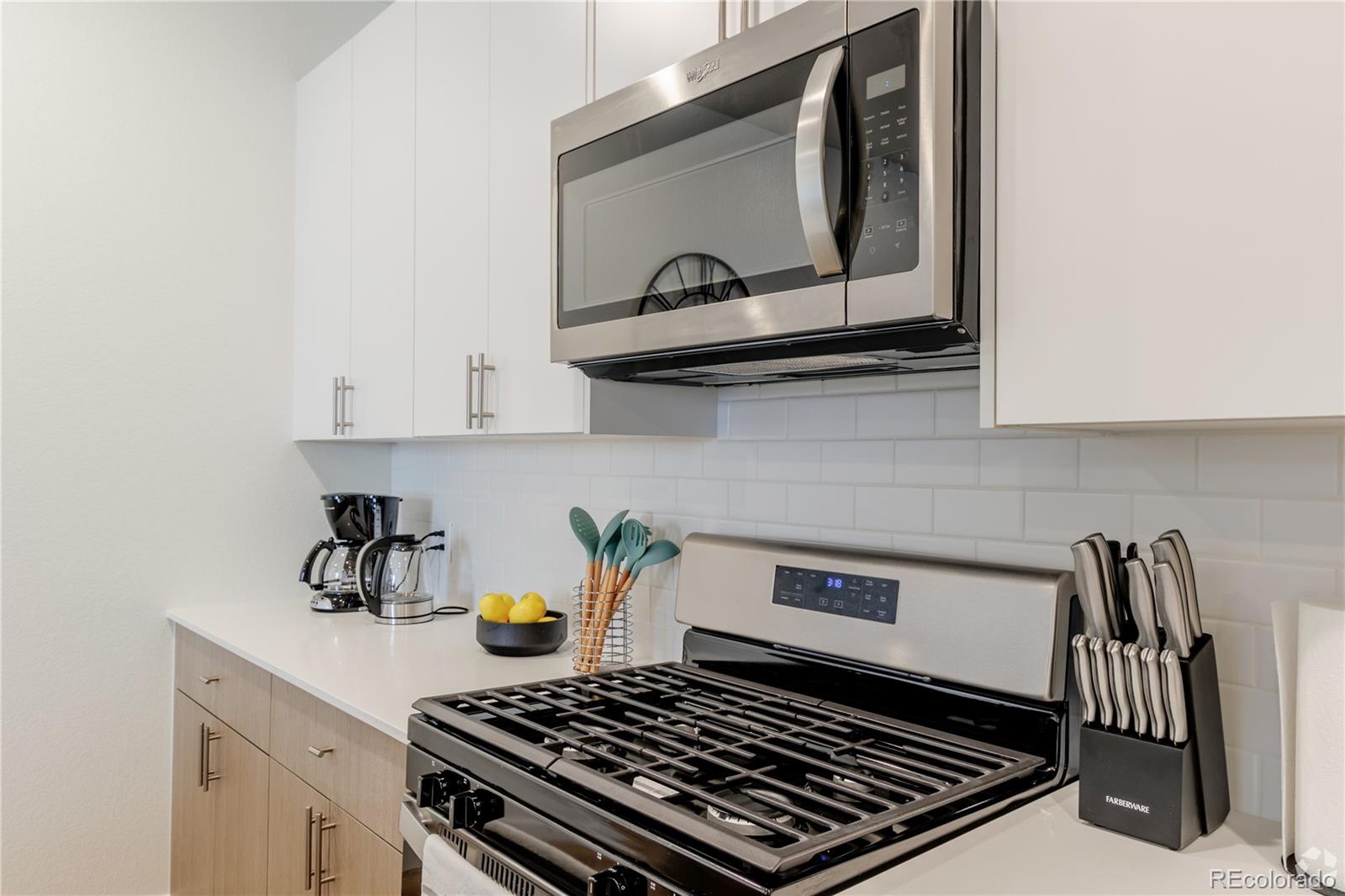 a stove top oven sitting inside of a kitchen