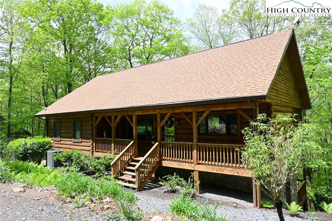 a view of a roof deck with wooden fence and a bench