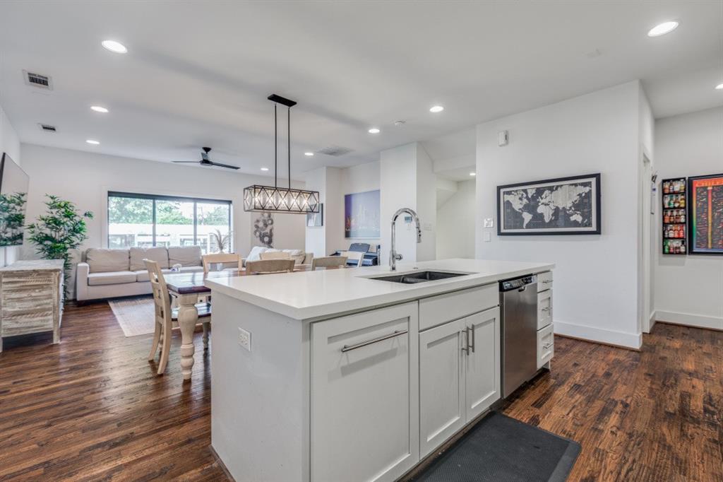 a kitchen with counter top space and wooden floor