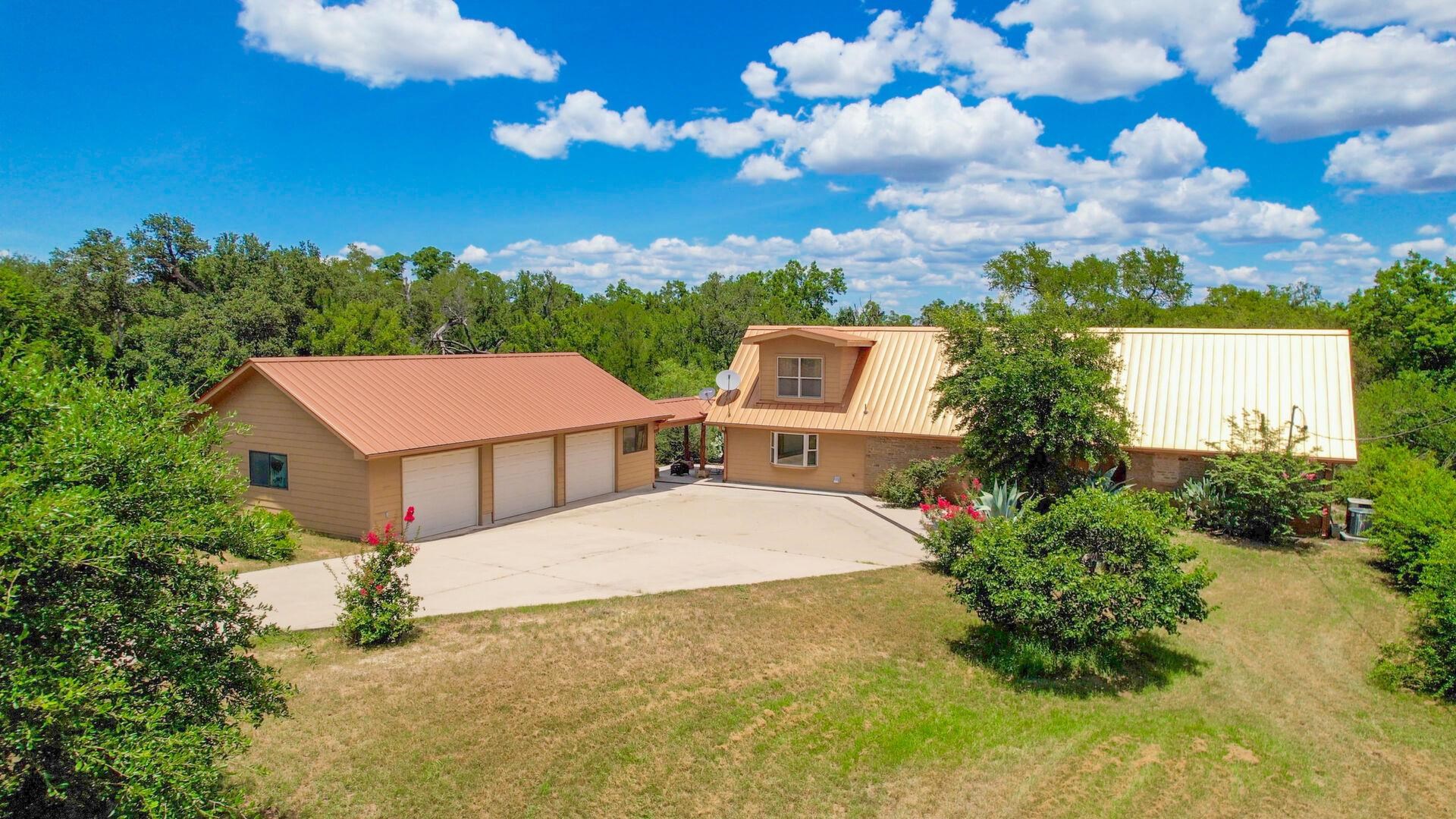 a aerial view of a house with yard and lake view