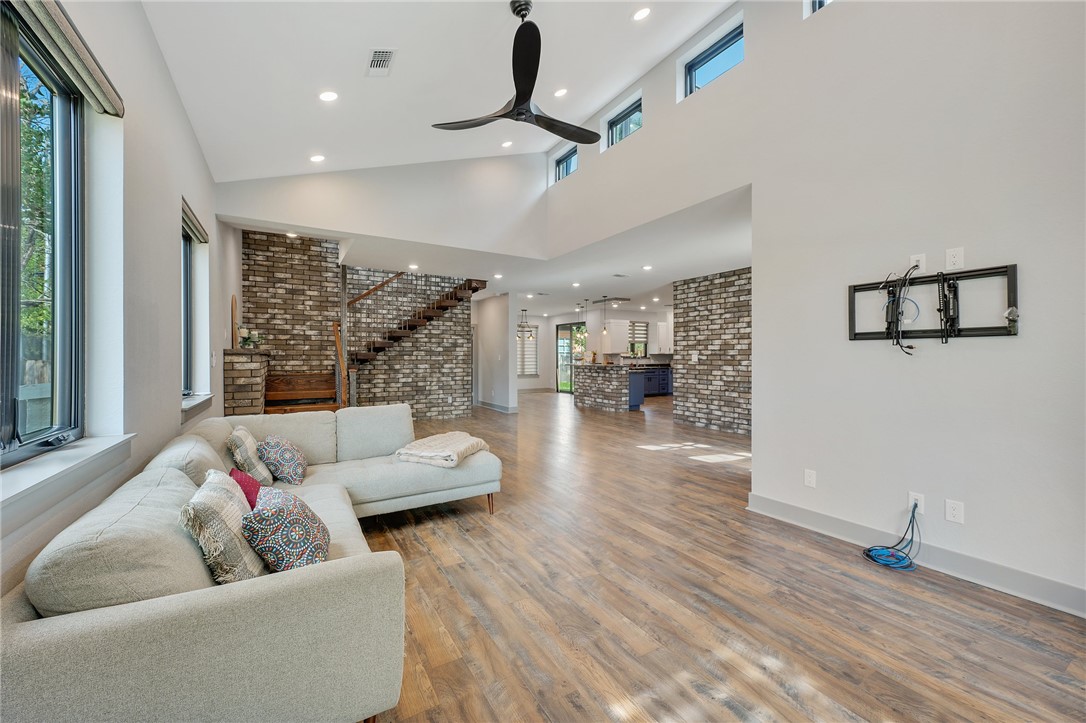 Living room featuring brick wall, hardwood / wood-