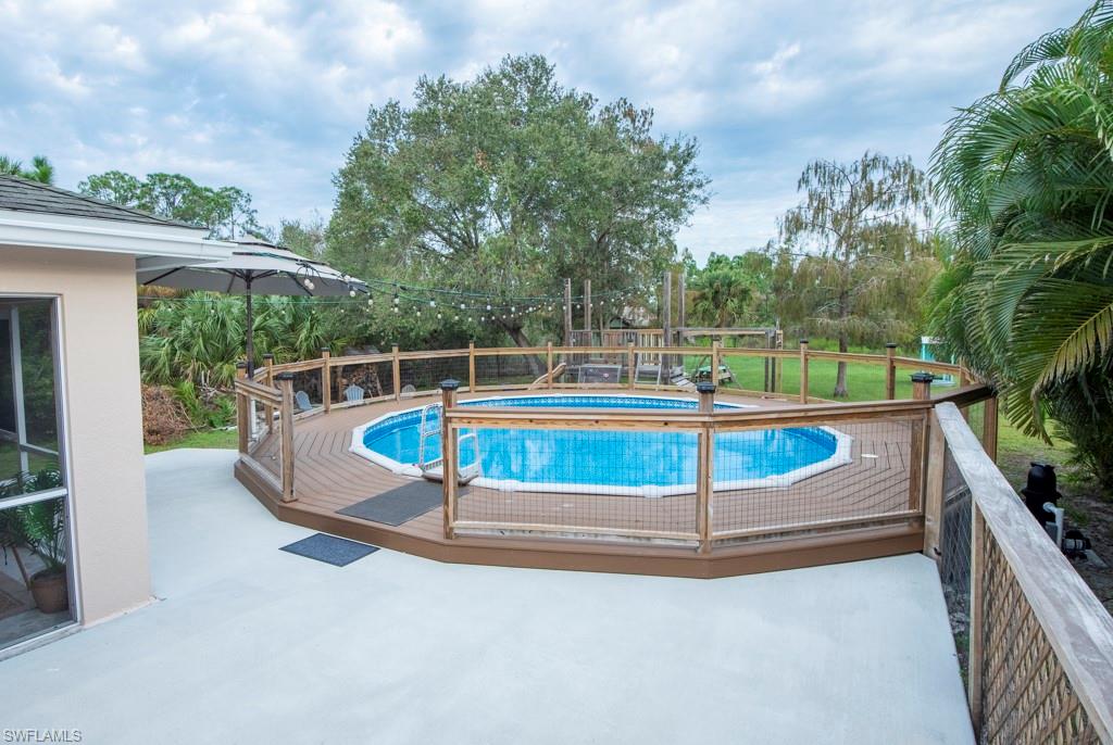 View of pool with a yard and a patio area