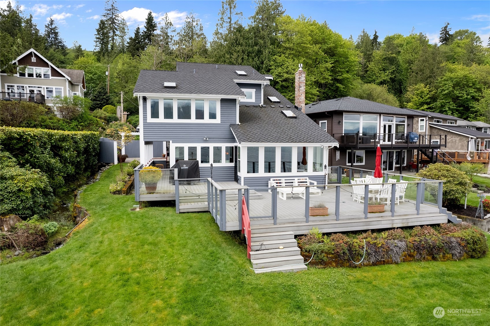 an aerial view of a house with swimming pool and garden