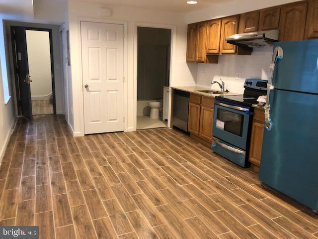 a kitchen with a sink and a stove