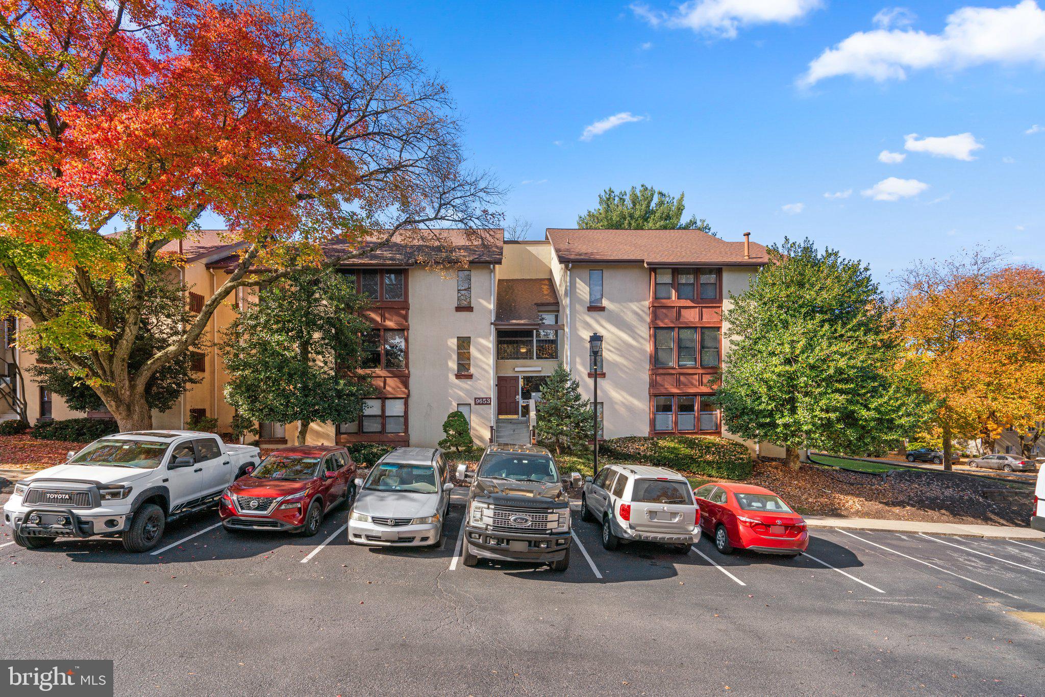 a view of a cars park in front of a building