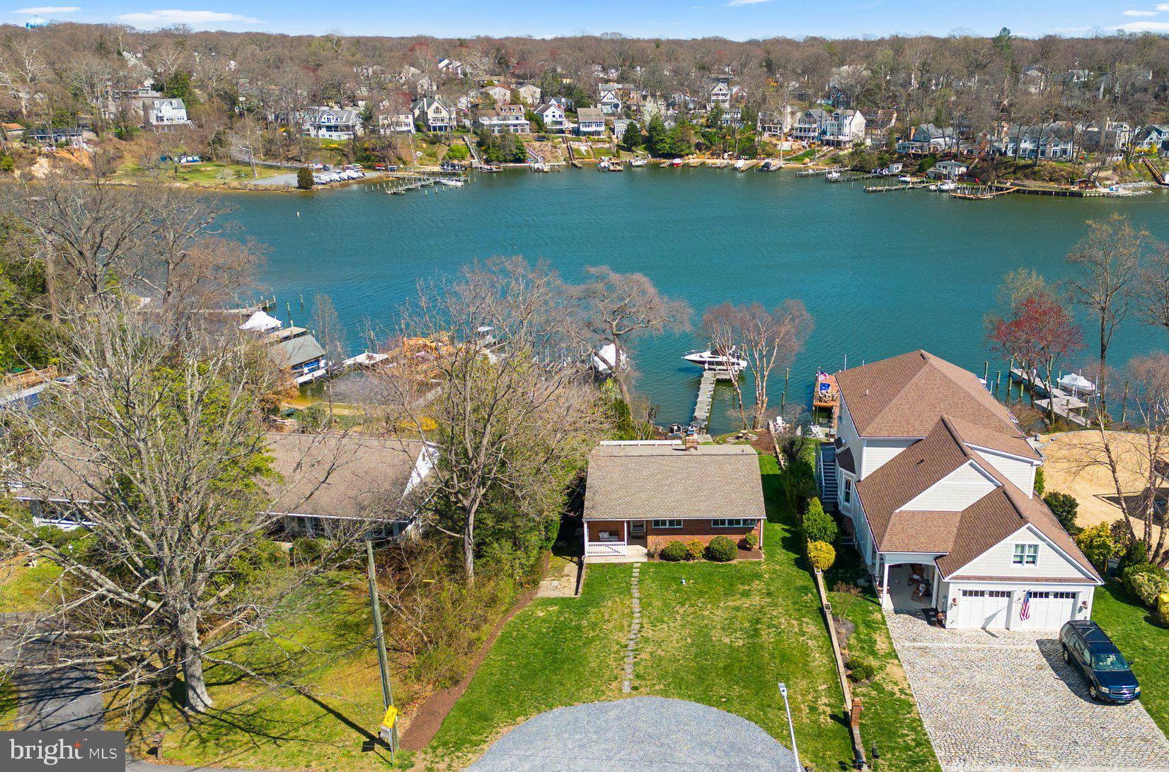 an aerial view of house with yard and lake view