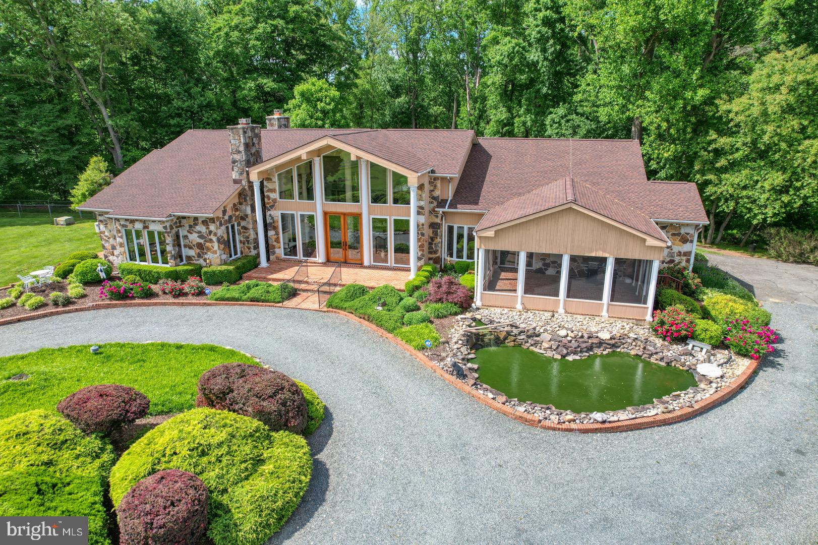 a front view of a house with swimming pool having outdoor seating