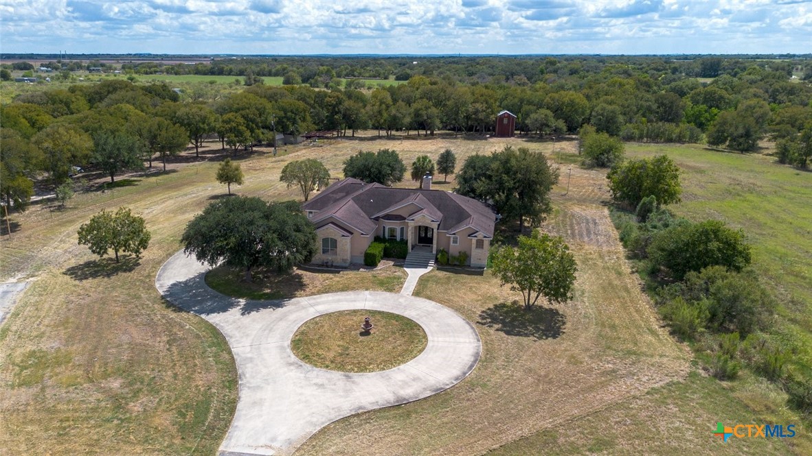 an aerial view of house with outdoor space and lake view