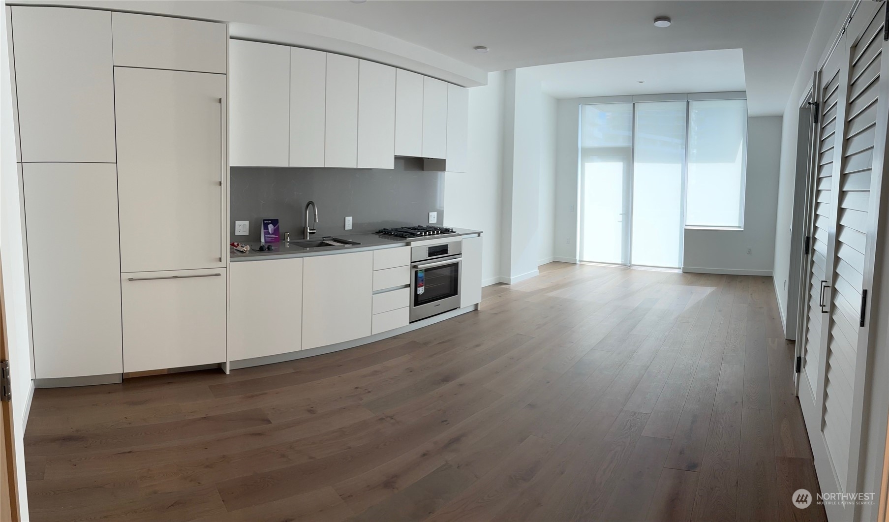 a kitchen with granite countertop a stove top oven a sink and a microwave