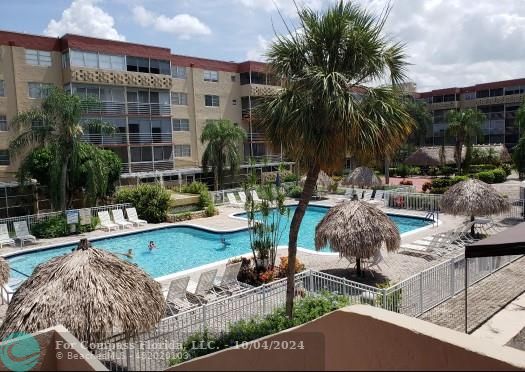 a view of swimming pool with outdoor seating and plants