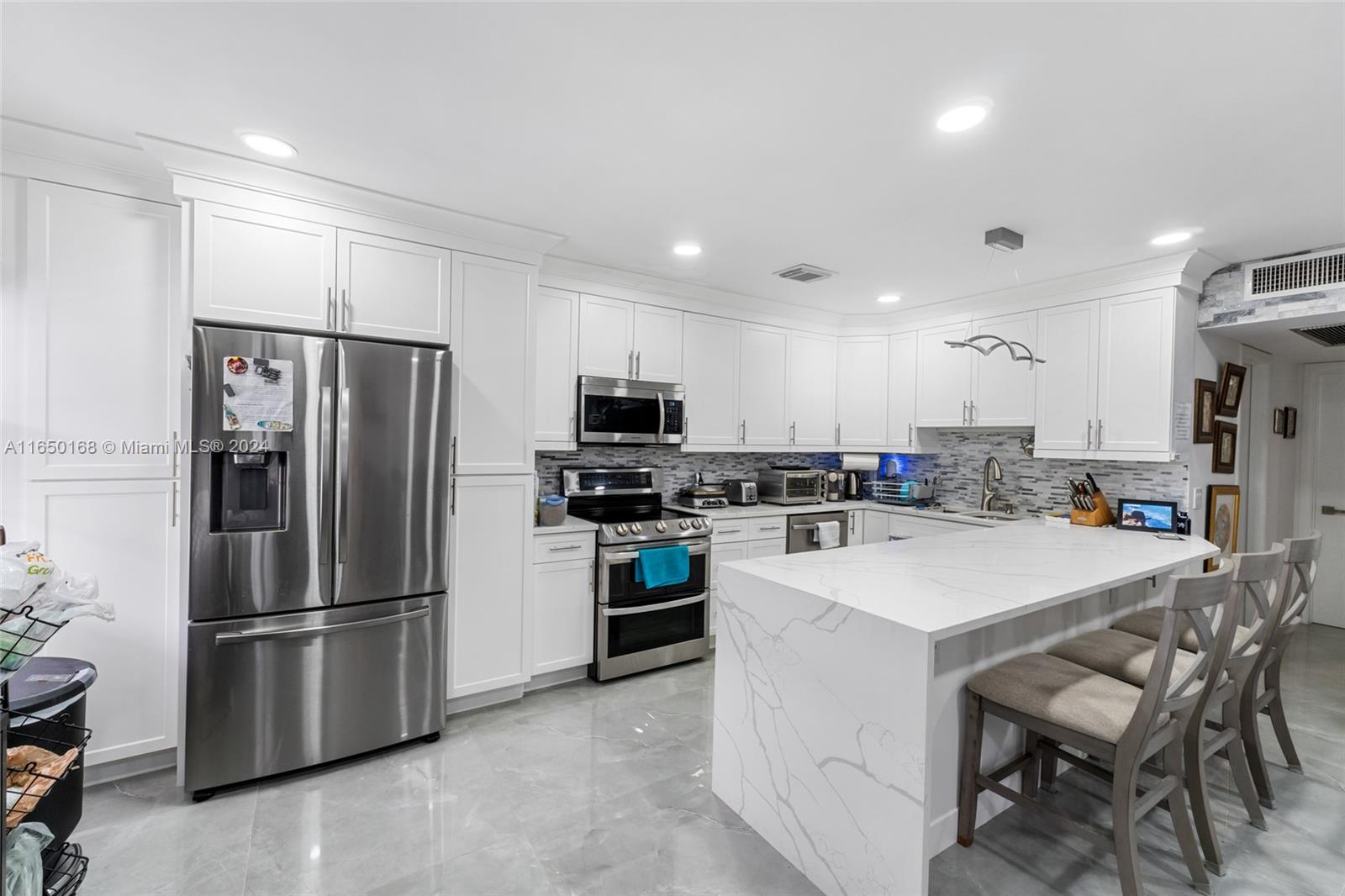 a kitchen with refrigerator a stove a sink and a refrigerator