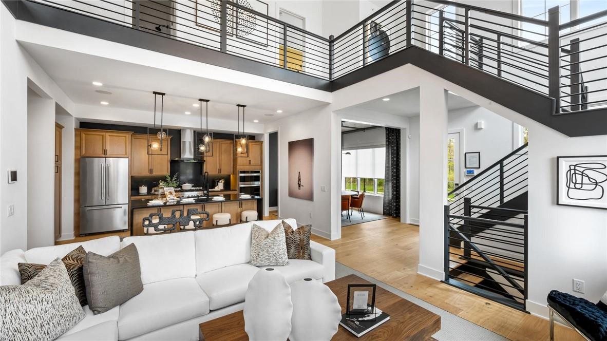 a living room with furniture a ceiling fan and a rug