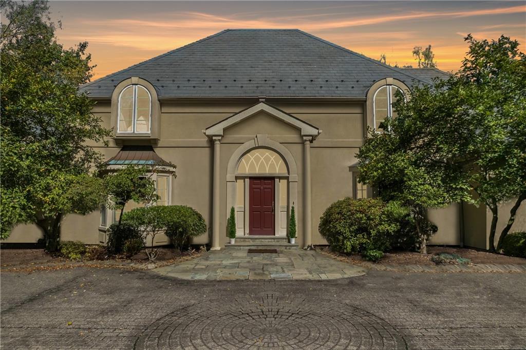 a front view of a house with garden