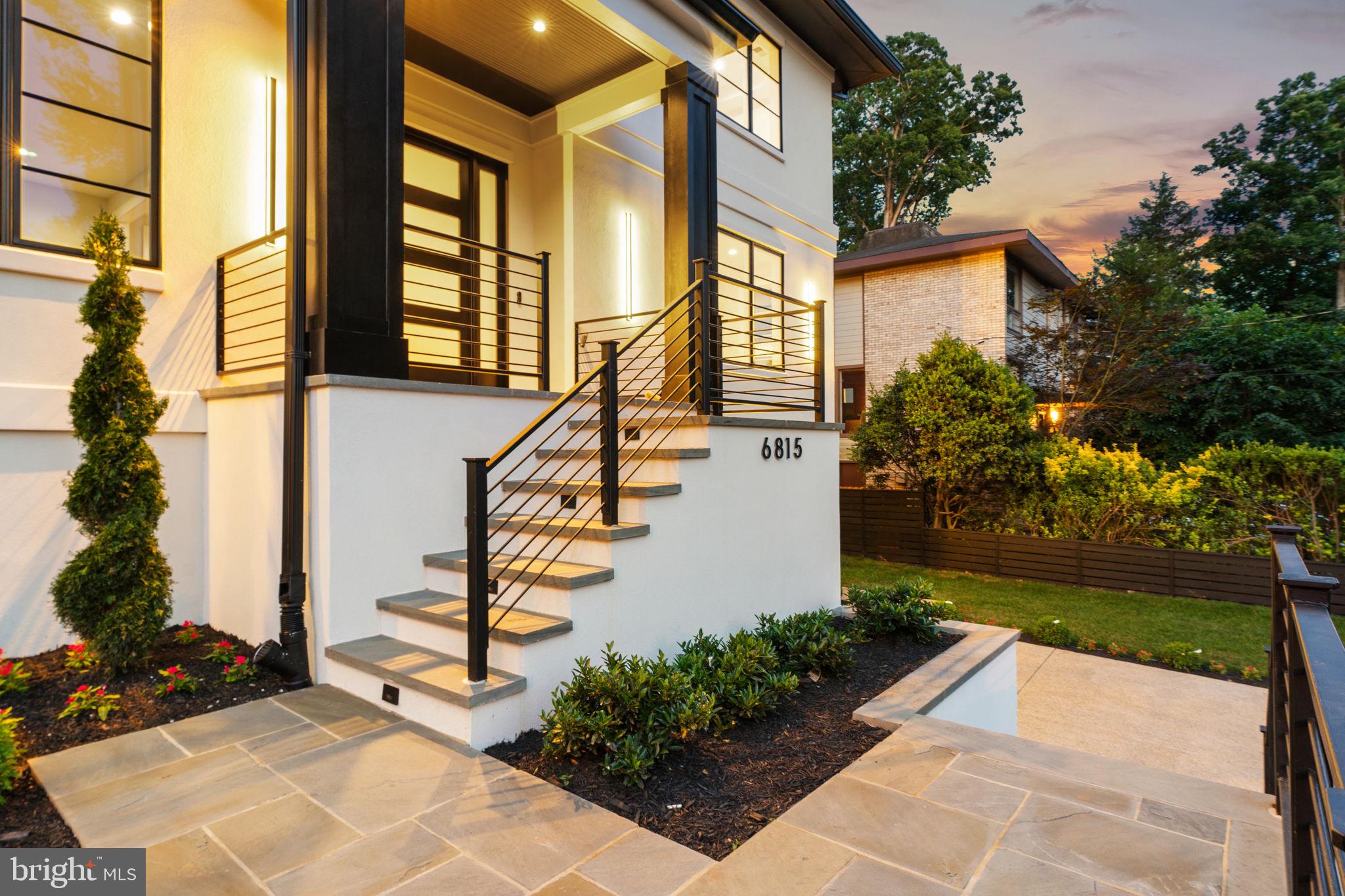 a front view of a house with a yard and trees