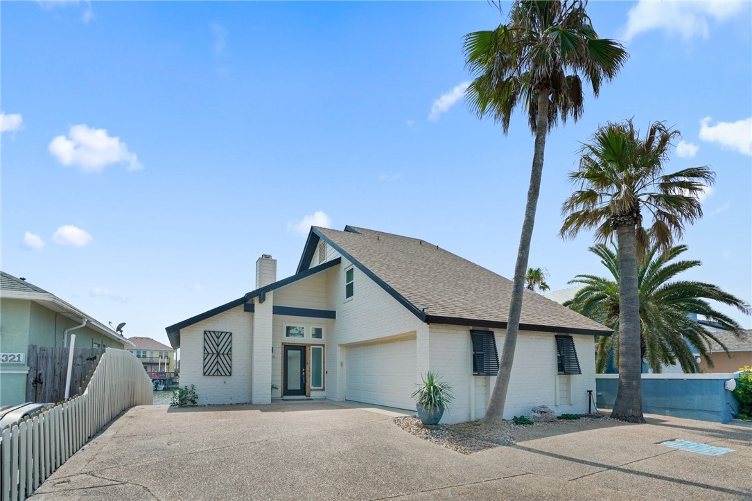 a view of a house with a yard and garage