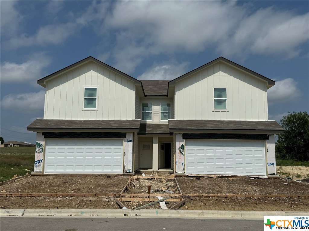 a front view of a house with garage